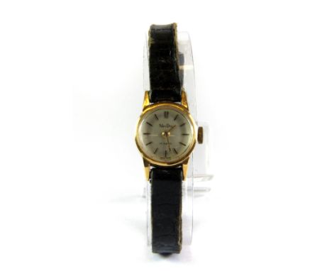 A lady's 18ct yellow gold wrist watch on a leather strap.