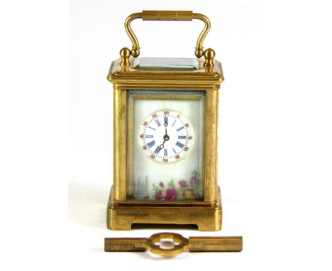 A porcelain panel and gilt metal miniature carriage clock, H. 7.5cm.