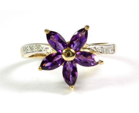 A 9ct yellow gold amethyst set flower shaped ring with diamond set shoulders, (M.5).