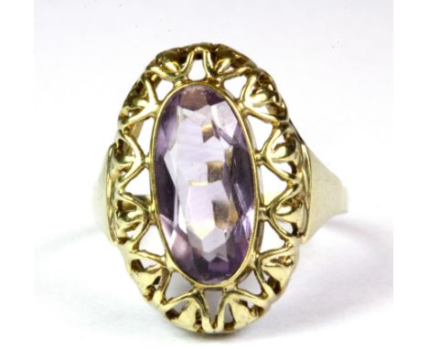 A 9ct yellow gold ring set with a large oval cut amethyst, (Q.5).