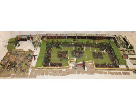 A large selection of Britains Ltd. garden including female with three children, elderly male and female on a garden bench, th