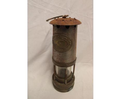 An old brass mounted steel miner's lamp by Thomas and Williams of Aberdare