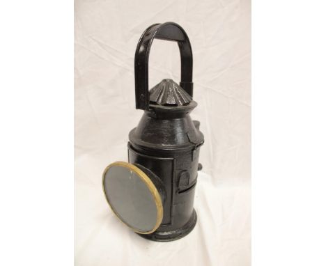 A painted metal and brass mounted railway hand lamp with internal oil fitment