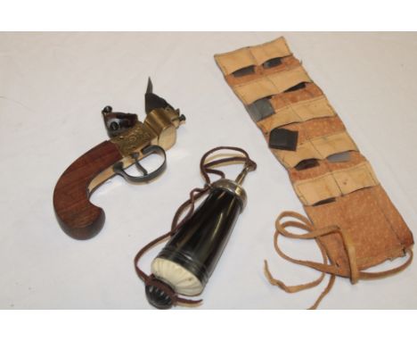 A reproduction flintlock eprouvette/tinder lighter with brass body and additional flints and a horn and antler mounted powder