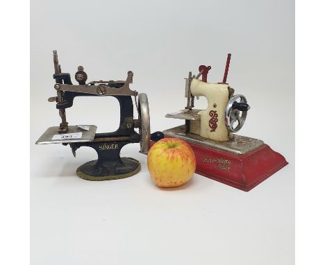A child's Singer sewing machine, a Little Betty Senior child's sewing machine, an Ace Film Projector, in original box, and a 