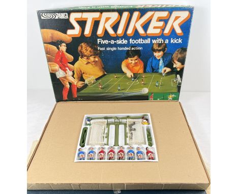 A boxed 1970's Parker Games Striker football game. Complete and with instructions and playing board/pitch. 3 players have bec