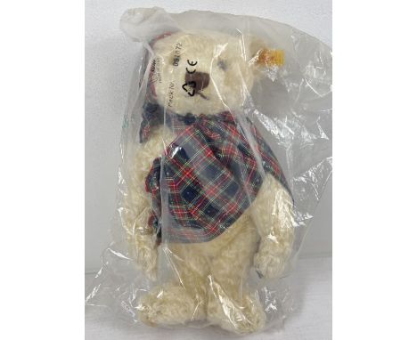 A 13" Steiff pale blonde mohair, fully jointed 'Winter 1997' teddy bear with growler. Wearing tartan fabric scarf and hat. In