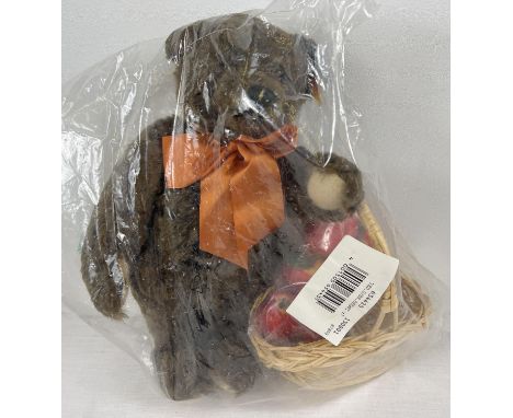 A 13" Steiff dark brown mohair, fully jointed 'Autumn 1997' teddy bear with growler. Wearing orange neck bow and with a baske