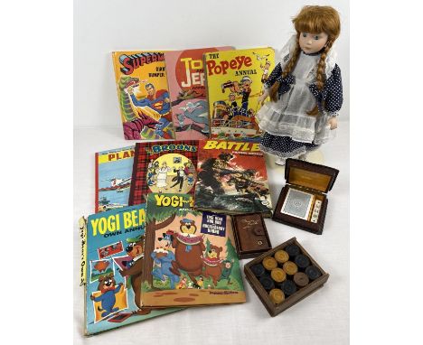 A box of assorted misc toys and books, to include vintage annuals, ceramic doll, playing cards and boxed wooden draughts. 