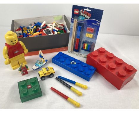 A collection of loose Lego and Lego merchandise. To include: Lego man torch, key ring torch, brick light, pencil case, storag