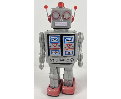 A vintage battery operated tin plate robot toy, possibly Japanese, approx. 12" tall. With moving parts, sounds and lights. In