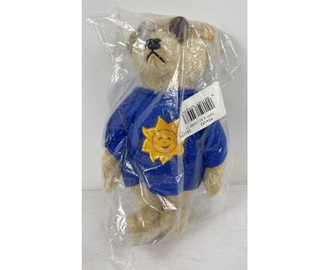 A 13" Steiff blonde mohair, fully jointed 'Summer 1997' teddy bear with growler. Blue fabric jumper with sun detail and weari