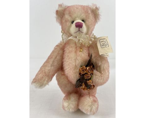 A 12" Limited Edition, fully jointed, mohair Grisly German teddy bear, named Pinky. With neck frill and holding a bunch of ro