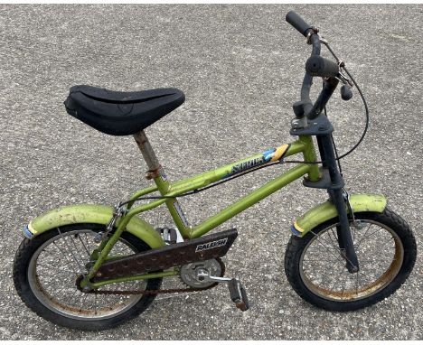 A vintage Raleigh "Stricka" children's bicycle in lime green with black seat, pedals and handlebars. Shows signs of age relat