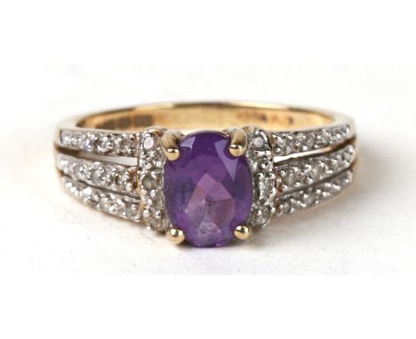 A 9ct gold amethyst ring with diamond set shoulders. Approx UK size P. 3g