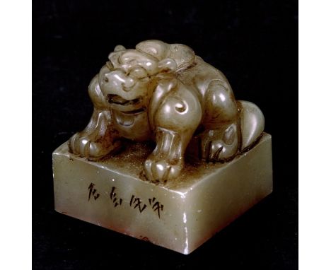 A Chinese carved stone desk seal surmounted a crouching kylin. 5cm (2 ins) high