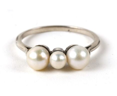 An unmarked white gold ring set with three pearls. Approx. UK size Q