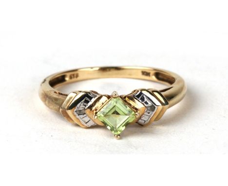 A 9ct gold peridot and diamond ring. Approx UK size N. 1.8g