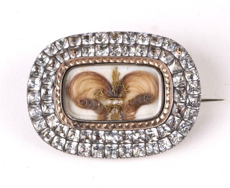 An early 19th century white and yellow metal mourning brooch, the central panel with hair work within a border of old cut pas