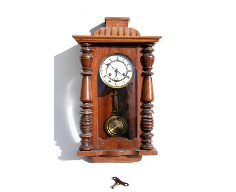 A Vienna style wall clock, the white enamel dial with Roman numerals.