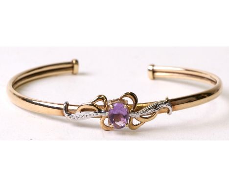 A 9ct gold bangle set with a large oval amethyst. 6.5cm diameter. 6.9gCondition Reporthallmarked for Sheffield 1994