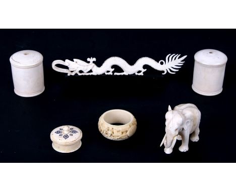 An early 20th century carved ivory elephant, an ivory dragon, an ivory napkin ring and other items. (6)