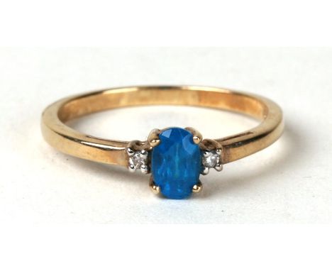 A 9ct gold ring set with blue stone and diamond set shoulders. Approx UK size N  1.5g