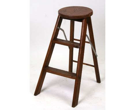 A folding oak two-step stool.