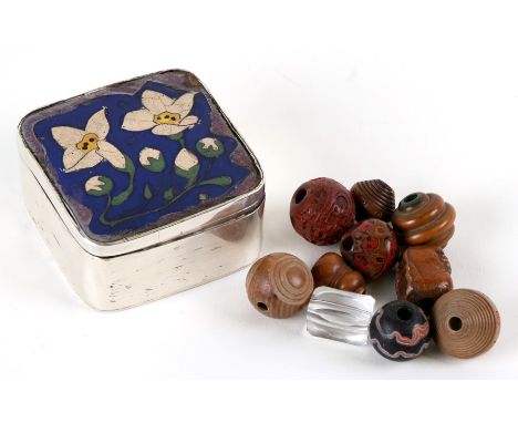 An oriental white metal box with cloisonné panel containing ten Japanese Ojime beads.