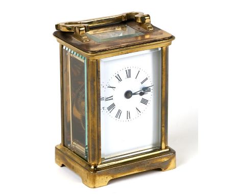 A carriage clock with white porcelain dial with Roman numerals, in a four pillar brass case, 7.75cms (3ins) wide.