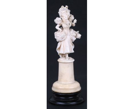 A 19th century Dieppe ivory figure in the form of a young lady holding a parasol, overall 23cms (9ins) high.Condition Reportp