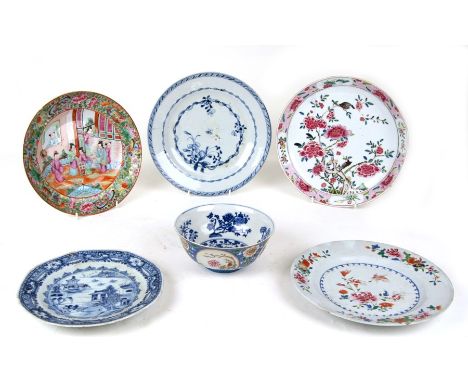 A Chinese famille rose bowl decorated with flowers within panels on a blue ground with a blue &amp; white interior, blue seal