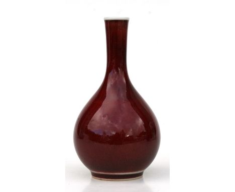 A Chinese red monochrome bottle vase with blue seal mark to the underside, 12cms (4.75ins) high; together with a Chinese blue