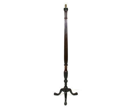 An early 20th century mahogany carved standard lamp on a tripod base, 168cms (62ins) high.