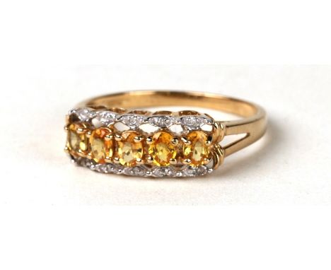 A 9ct gold yellow stone( possibly topaz) and diamond ring. Approx UK size T 2.6g