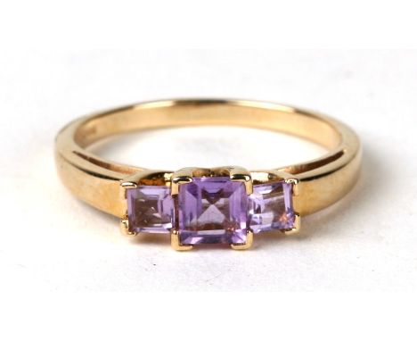 A 9ct gold ring set with three pale square cut amethyst. Approx UK size N. 2.6g