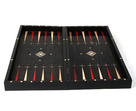 An ebony and ivory folding backgammon/ chess board. 46cm (18ins) wideCondition ReportSome losses and lifting to the ivory str