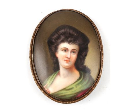 An oval portrait miniature porcelain plaque depicting Miss Sheridan, after Gainsborough, 5 by 7cms (2 by 2.75ins).