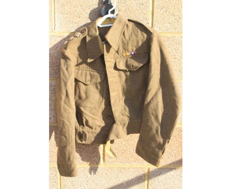 A WW2 British Army Captains Battledress jacket with cloth pips, in a very good condition, it hardly looks worn. Size accordin