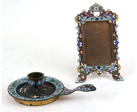 A late 19th century brass,champleve enamel and pietra dura decorated chamber stick together with a champleve enamel picture f