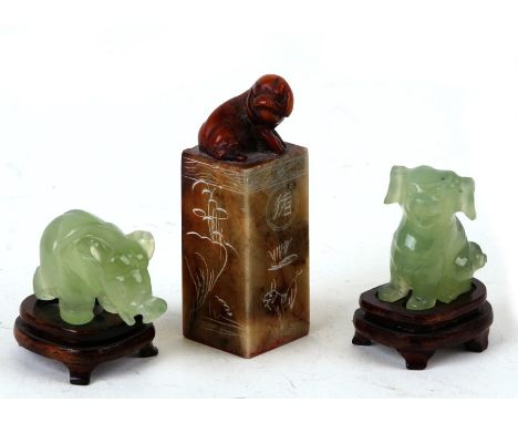 A Chinese jade elephant on stand, 5cms (2ins) high; together with a Chinese jade Peking dog, 4cms (1.5ins) high; and a Chines