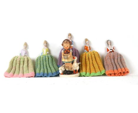 A Goebel figure in the form of a girl feeding geese, 11cms (4.25ins) high; together with a group of porcelain half dolls.