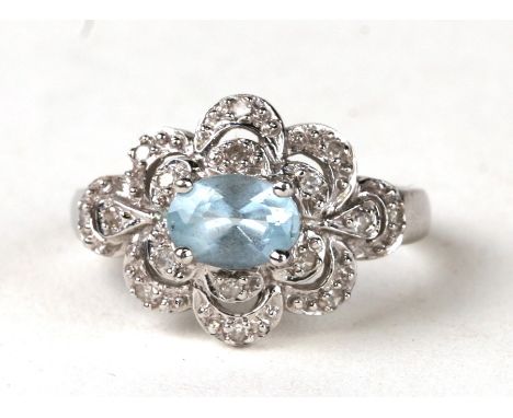 A 9ct white gold pale blue stone and diamond ring. Approx UK size M  3.7g