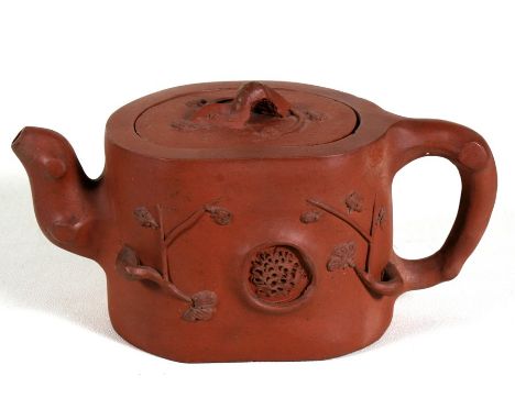 A Chinese Yixing pottery teapot decorated with prunus, impressed seal mark to the underside, 9cm (3.5ins) high. Condition Rep