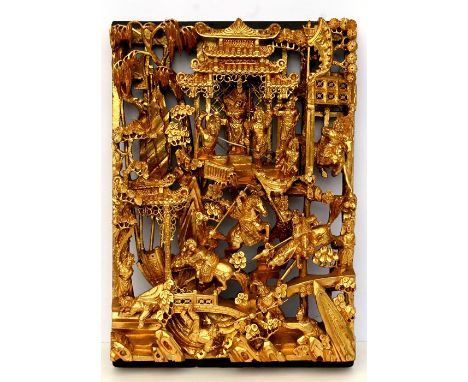 A Chinese carved and pierced giltwood panel decorated with figures in a battle scene, 29 by 42cms (11.5 by 16.5ins).