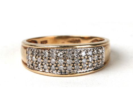 A 9ct gold ring set with three rows of diamonds. Approx UK size N 2.6