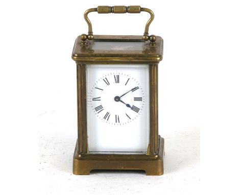 A brass cased carriage clock, the white enamel dial with Roman numerals, 12cms (4.75ins) high.