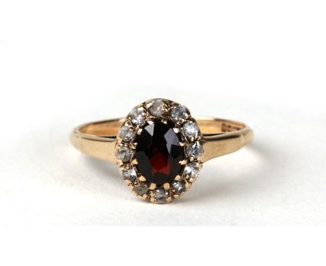 A 9ct gold garnet cluster ring Approx UK size R. 2.2g