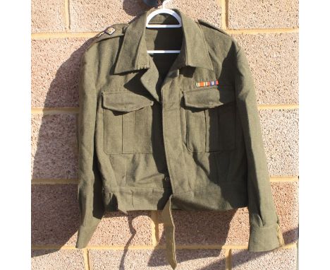 A WW2 British Army Captains Battledress jacket with cloth pips and Divisional patches, in a very good condition, it hardly lo