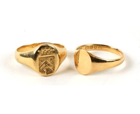 A yellow metal signet ring (test as 18ct) with engraved crest; together with an 18ct gold signet ring, both UK size 'M', weig